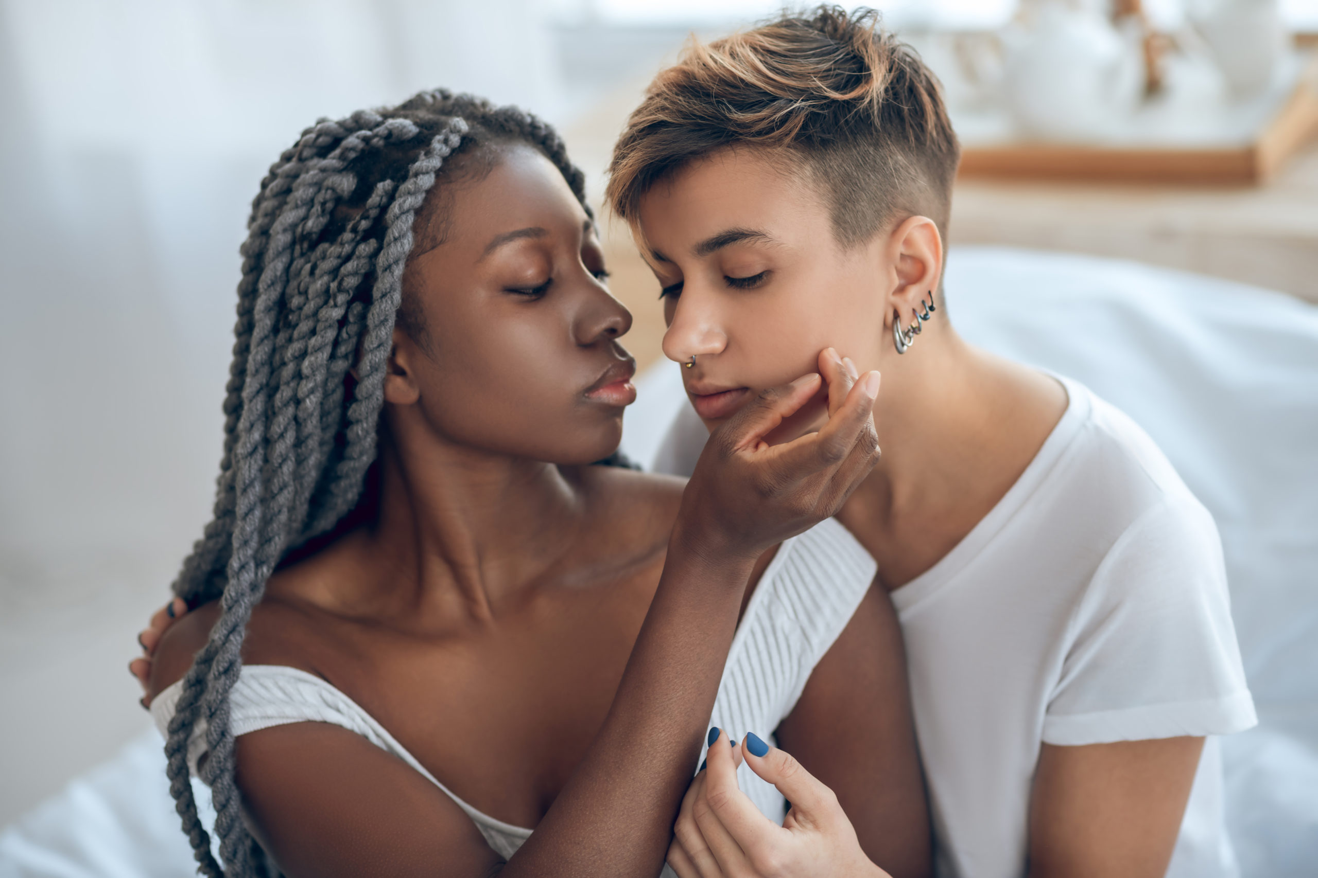 Same sex couple of mixed race connecting and expressing desire for one another.
